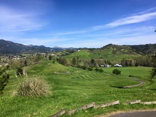 View of a green and fairway at Myrtle Creek Golf Club