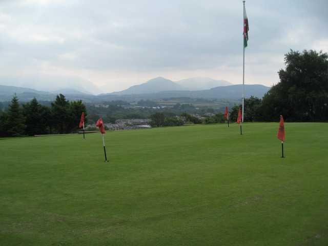 The putting green with surrounding mountains at St Deiniol Golf Course