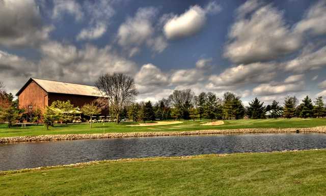 A view of a green surrounded by water at Raccoon Hill Golf Club