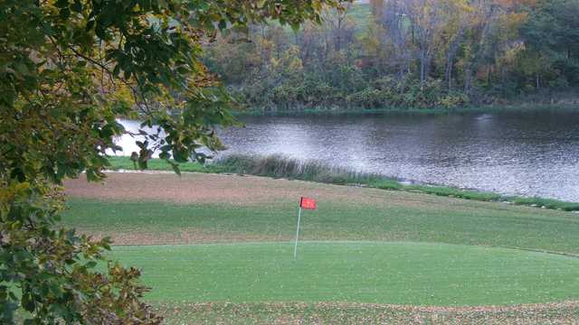 A fall view of a green with water coming into play at Majestic Hills Golf Course