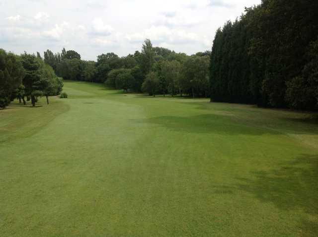 The tree lined 1st fairway at  Cocks Moors Woods Golf Club