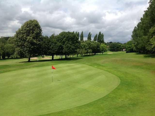 The beautiful 1st green and tree lined faiway at Harborne Church Farm Golf Club