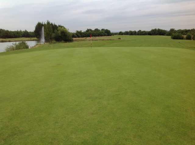 View of the 18th green and pond at Park Hill Golf Club