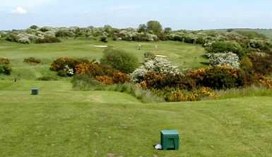 Tee off over the beautiful gorse on the 17th at Dyke Golf Club