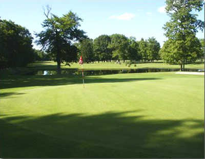 A view of the 11th hole with water in background at Pine Grove Golf Course