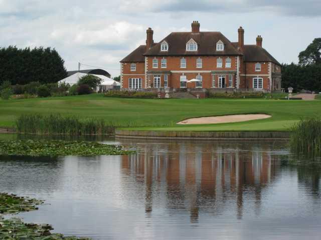 Beautiful view over the lake of the 18th green and clubhouse at The Astbury