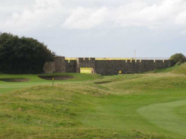 The 1st green at Leasowe with the castle wall as backdrop