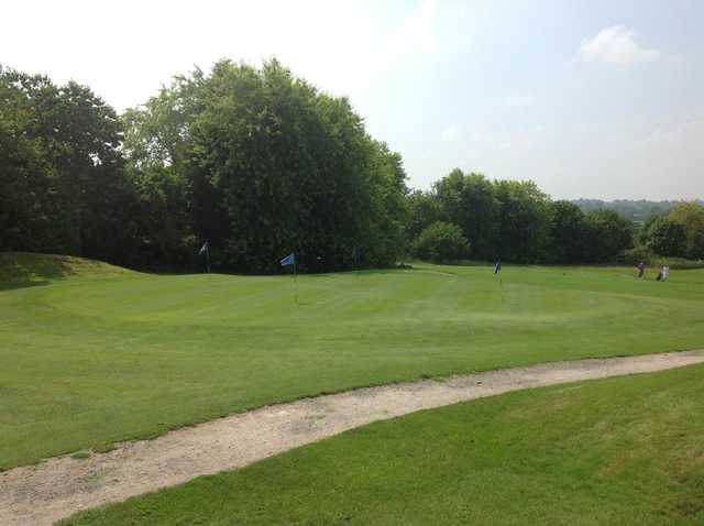 A view of the chipping green and surrounding trees at Lindfield Golf Club