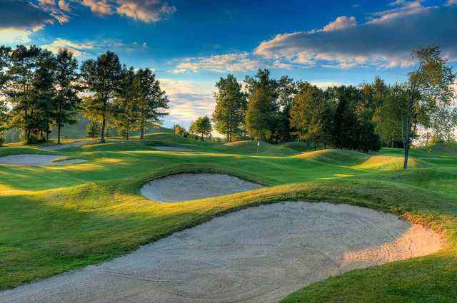 A splendid view of a green surrounded by a collection of tricky bunkers from The Golf Club at Mt. Brighton