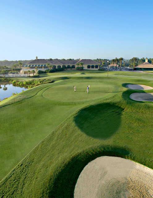 View of a green and clubhouse at LPGA International