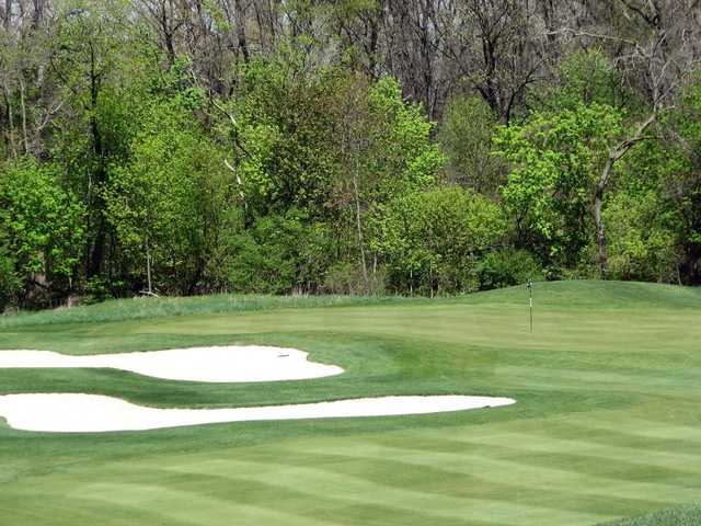 A spring view of a hole surrounded by sand traps at Monroe Golf & Country Club