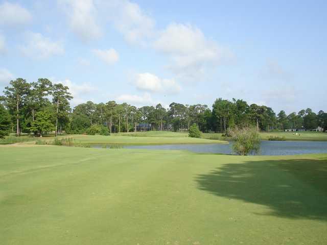 A view of a green surrounded by water at Hickory Hill Country Club