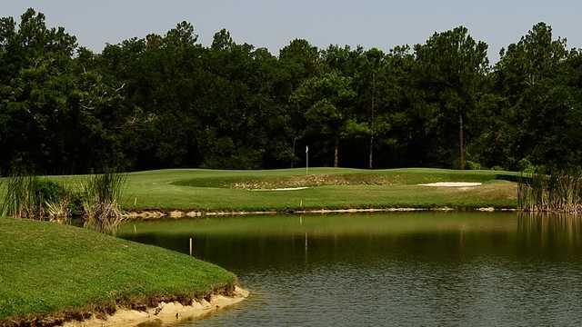 A view of the 12th hole surrounded by water at The Oaks Golf Club