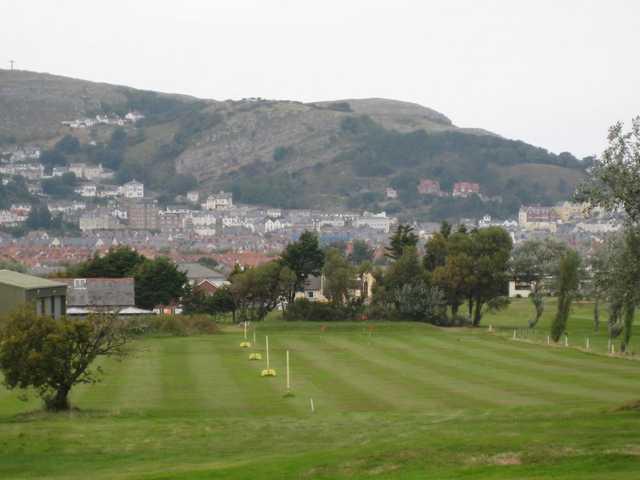 The practice ground and picturesque mountain backdrop at Llandudno Maesdu Golf Club