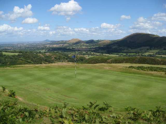 A view of the 7th green overlooking a stunning mountain backdrop at Church Stretton Golf Club