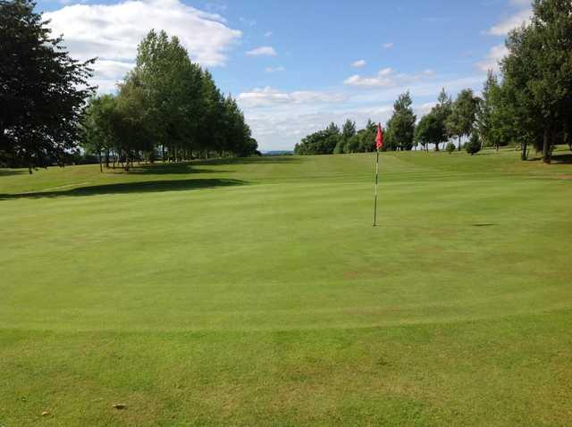 A view of the 9th green and tree lined fairway at Arscott