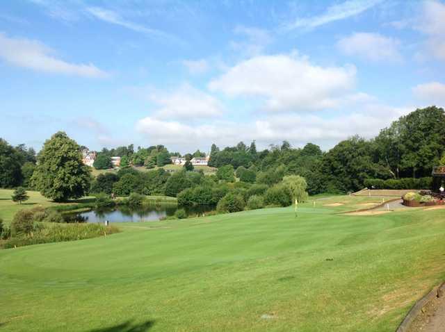 Scenic view of the 9th green overlooking the lake and clubhouse at Westerham Golf Club