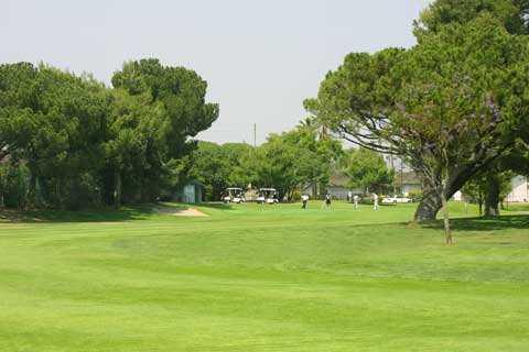 A view of hole #14 with golf carts in background at Dad Miller Golf Course