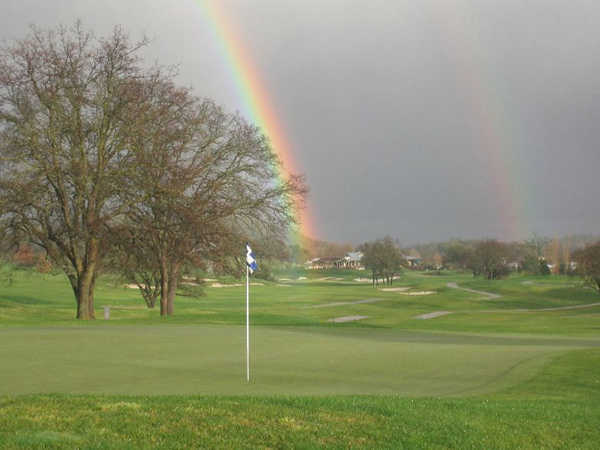A view of the 2nd hole with rainbow in backgroun at Greenhorn Creek Golf Course