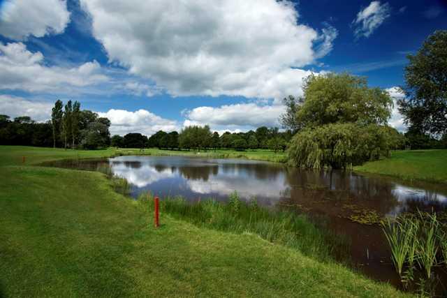 Scenic view across the pond of the 9th hole at Tytherginton Golf Club