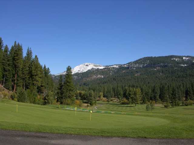 A view of the practice putting green and the driving range in the distance at Plumas Pines Golf Resort