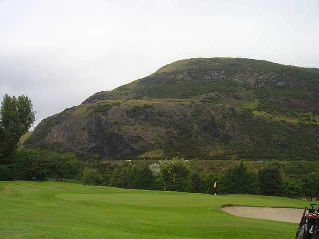 Towering hills alongside a green at Prestonfield
