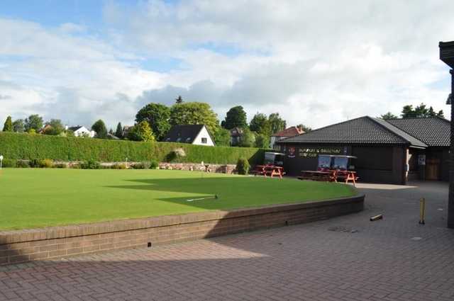 The clubhouse and putting green at Dumfries & Galloway Golf Club