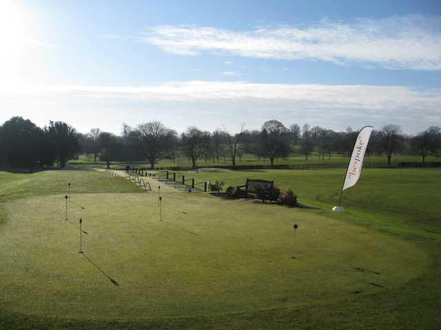 View from the clubhouse of the putting green and driving range at The Welcombe Golf Club