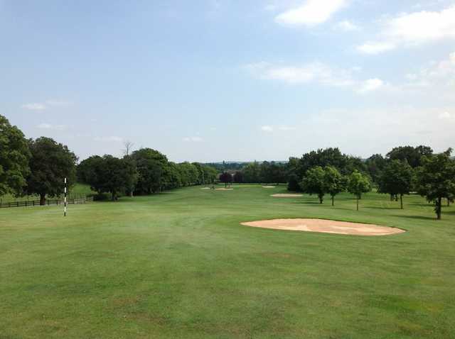 A scenic view of the challenging 18th hole at The Welcombe Golf Club