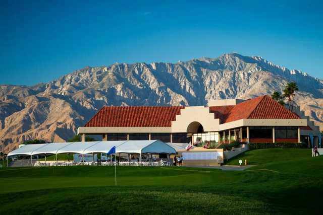 A view of the clubhouse at Desert Dunes Golf Course  with green in foreground