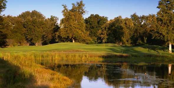 A view of a green with water in foreground at Cherry Island Golf Course