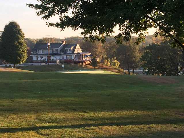 A view of the clubhouse and practice putting green at Hillsboro Country Club