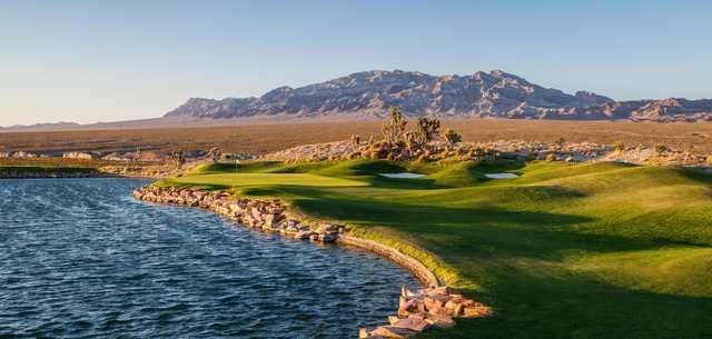 With a spectacular view of Sheep Mountain, the par-3 16th at Snow Mountain requires a long carry over water.