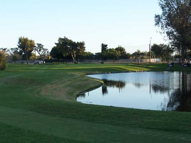 A view from Meadowlark Golf Course with golf carts in background and water on the right.