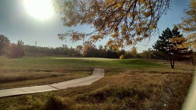 A sunny view of a hole at Indian Hill Golf Course