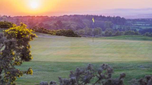 Sunset view of a green at Isle of Purbeck Golf Club