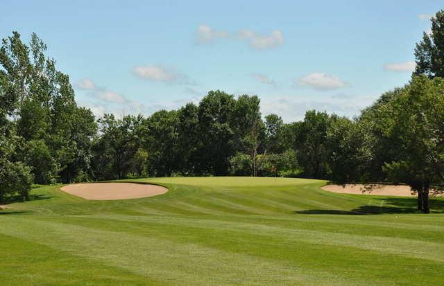 A view of the 7th green flanked by sand traps at Grand Forks Country Club