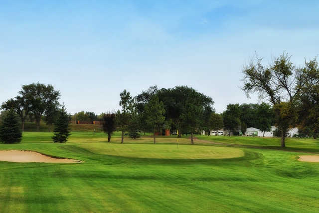 A view of a green flanked by bunkers at Mandan Golf Course