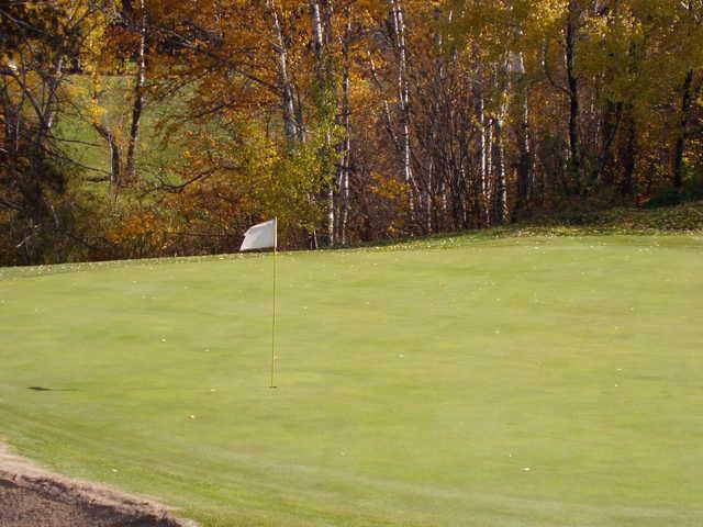 A fall view of a green at Eveleth Golf Course