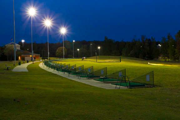 An evening view of the driving range tees at Knight's Play Golf Center