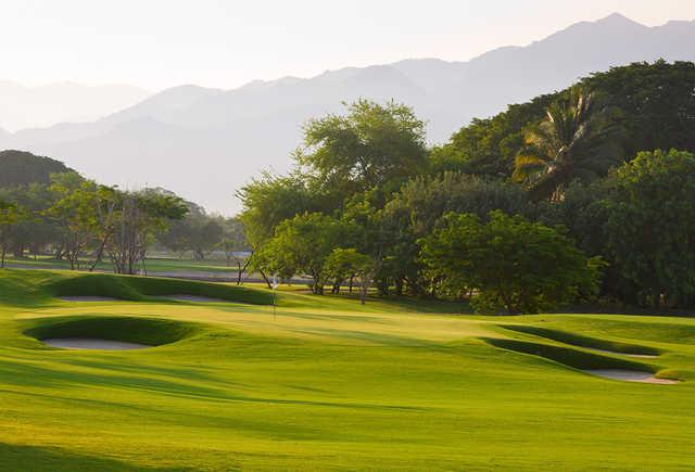 A sunny day view of a hole at The Greg Norman Signature Course from Vidanta Nuevo Nayarit-Vallarta