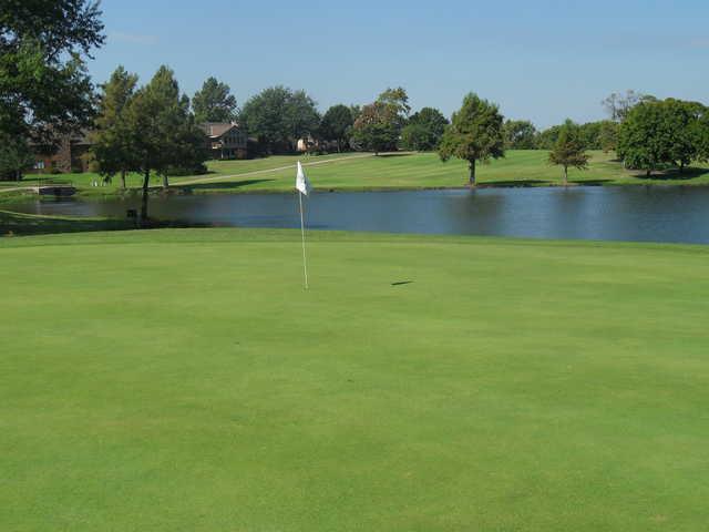 A view of a green with water coming into play at Adams Golf Club