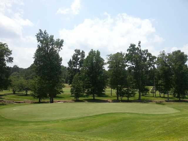 A sunny day view of a green at Northwoods Golf Course