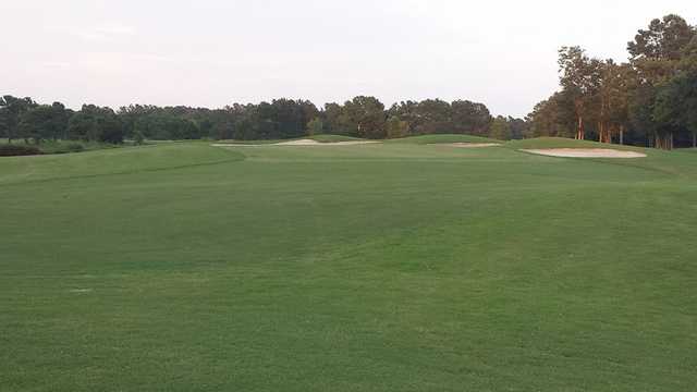 View of a green and bunkers at Meadowlands Golf Course