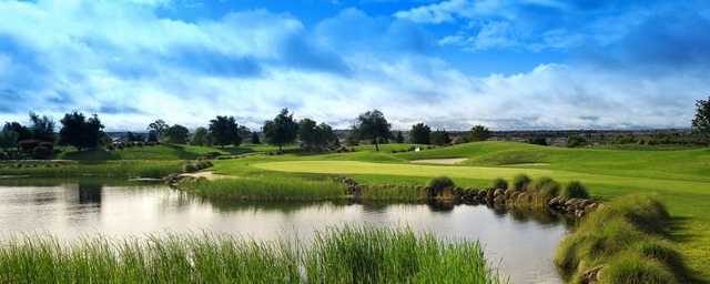 A green view with water on the right at The Lincoln Hills Golf Club