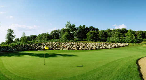 A sunny day view of a hole at Two Oaks North Golf Club