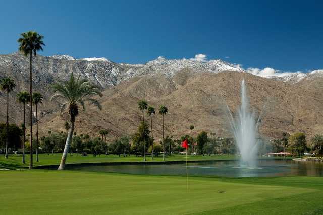 A view of the 9th green with Disney Fountain and snow capped San Jacinto mountains in the background at North Course from Indian Canyons Golf Resort.