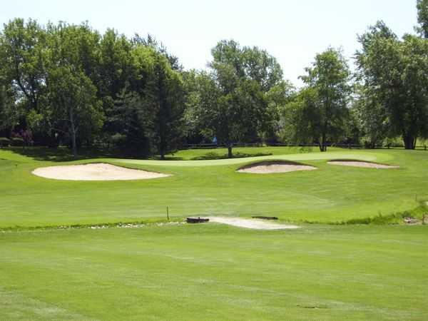 A view of a green protected by bunkers at Crystal Woods Golf Club