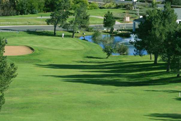 A view of a green with a bunker on the left at Indian Hills Golf Club .