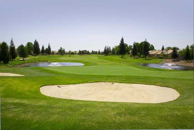 A view of the 3rd green with bunker in foreground at Lakes/Oaks from Timber Creek Golf Course.